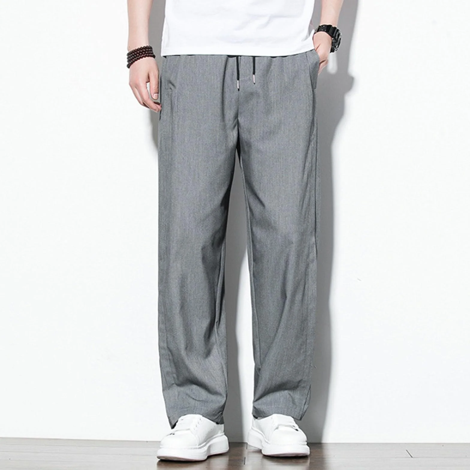 Pantaloni lunghi da uomo estivi a gamba larga in tessuto con tasche tinta unita